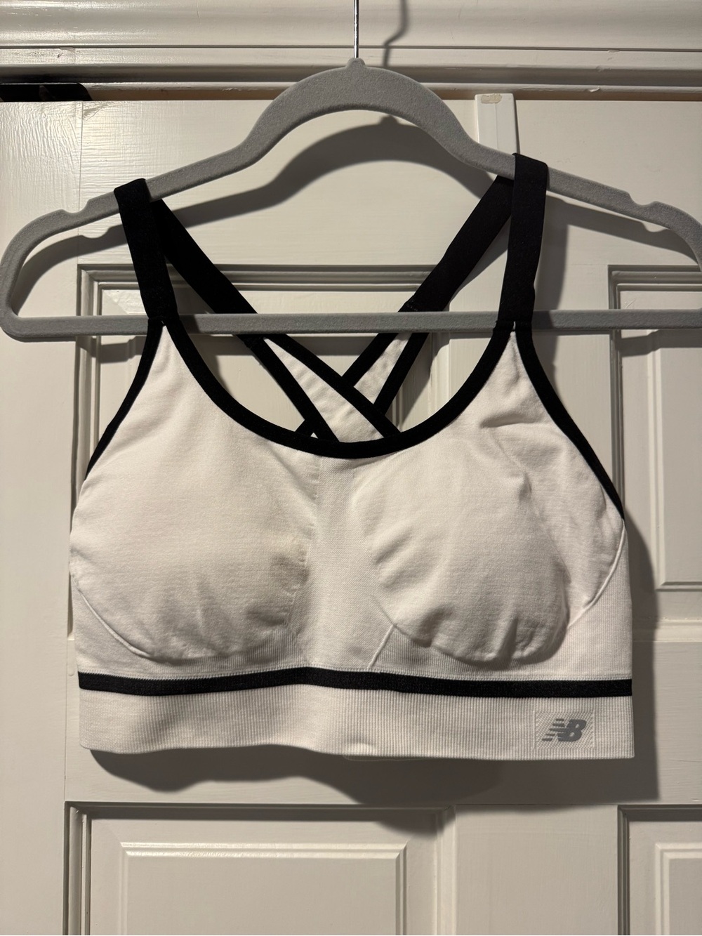 New Balance White Sports Bra with Black Trim and Crisscross Straps